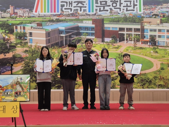 ▲ 객주문학관 글짓기 및 그림그리기 대회에서 대상을 차지한 청송초 배민규(오른쪽 첫 번째) 학생과 이하은(오른쪽 두 번째) 학생이 윤경희 군수와 기념 촬영을 하고 있다.