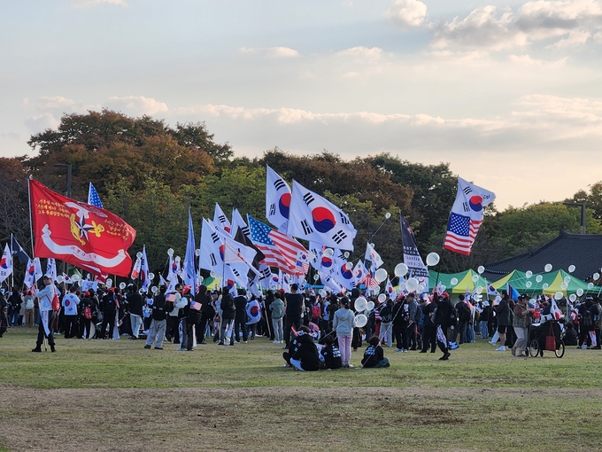 ▲ 경주 보문단지 인근에서 열린 자유대학 주최 집회 참가자들이 태극기와 성조기를 흔들며 트럼프 지지 구호를 외치고 있다. 서의수 기자