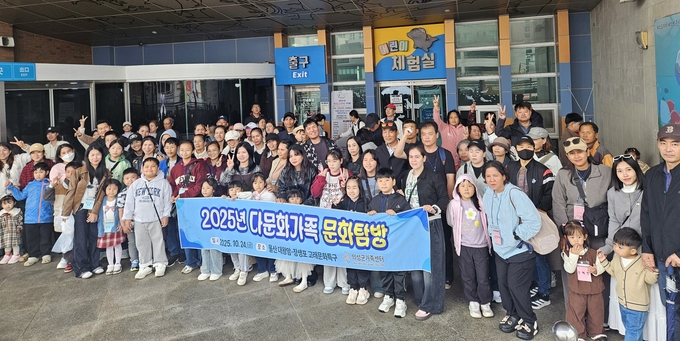 ▲ 의성군가족센터 관계자와 다문화가족 100여 명이 24일 울산 장생포 고래문화특구 어린이체험실 앞에서 ‘2025년 다문화가족 문화탐방’ 현수막을 들고 단체 기념촬영을 하며 해양생태체험 일정을 시작하고 있다. 의성군