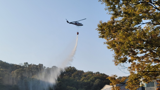 ▲ 구미시에서 임차한 소방헬기가 ‘2025년 재난대응 안전한국훈련’현장인 금오산에 물을 뿌리며  산불진화를 시도하고있다. 이봉한기자