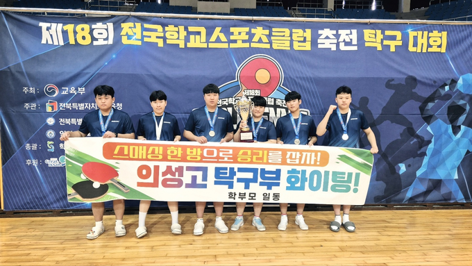 ▲ 11월 9일 전북 익산생활체육관에서 열린 제18회 전국학교스포츠클럽 축전 탁구대회 시상식 후, 의성고등학교 탁구부 선수들이 남고부 준우승 트로피를 들고 기념촬영을 하고 있다. 사진은 왼쪽부터 정지우, 이동규, 오준목, 이종현(주장), 정남규, 강지원 학생이 은메달을 걸고 학부모 격려 현수막을 펼쳐 보이며 환하게 웃고 있다. 의성고